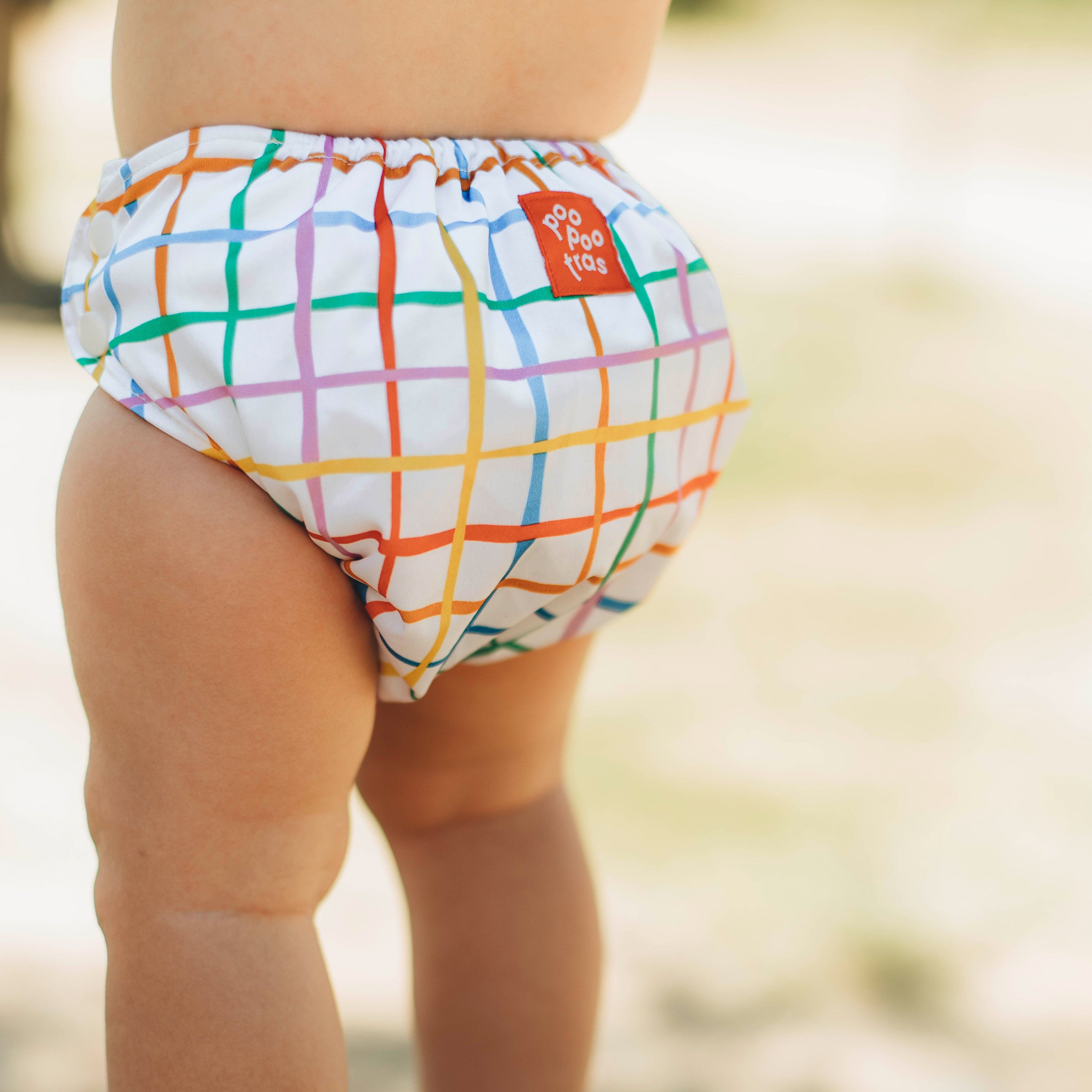 Panal de tela lavable y ecológico, evolutivo y diseño poopootras - llevado por un bebé